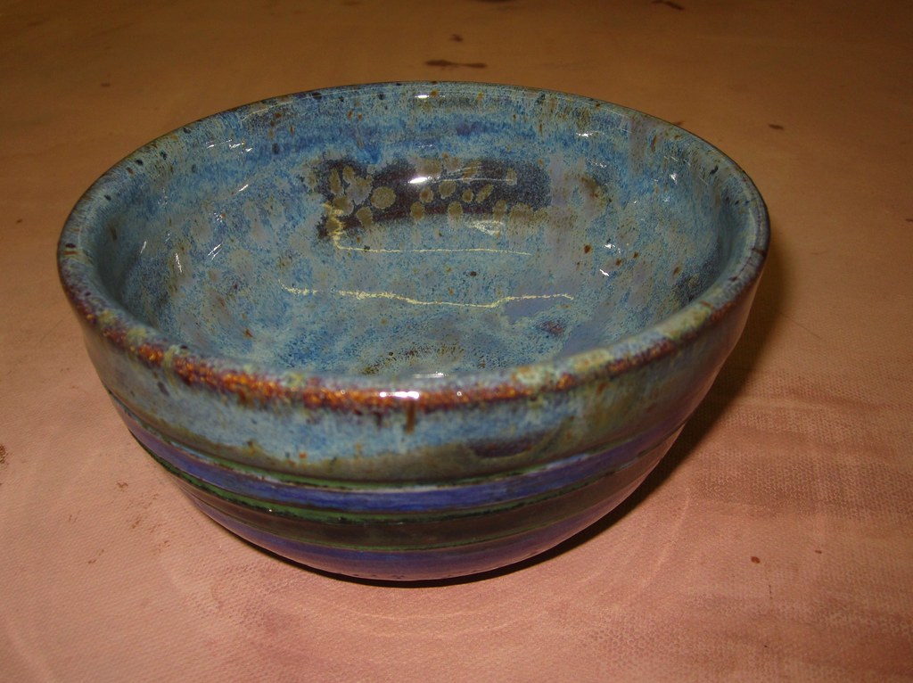 Finished glazed ceramic bowl after kiln firing showing rich color glaze surface