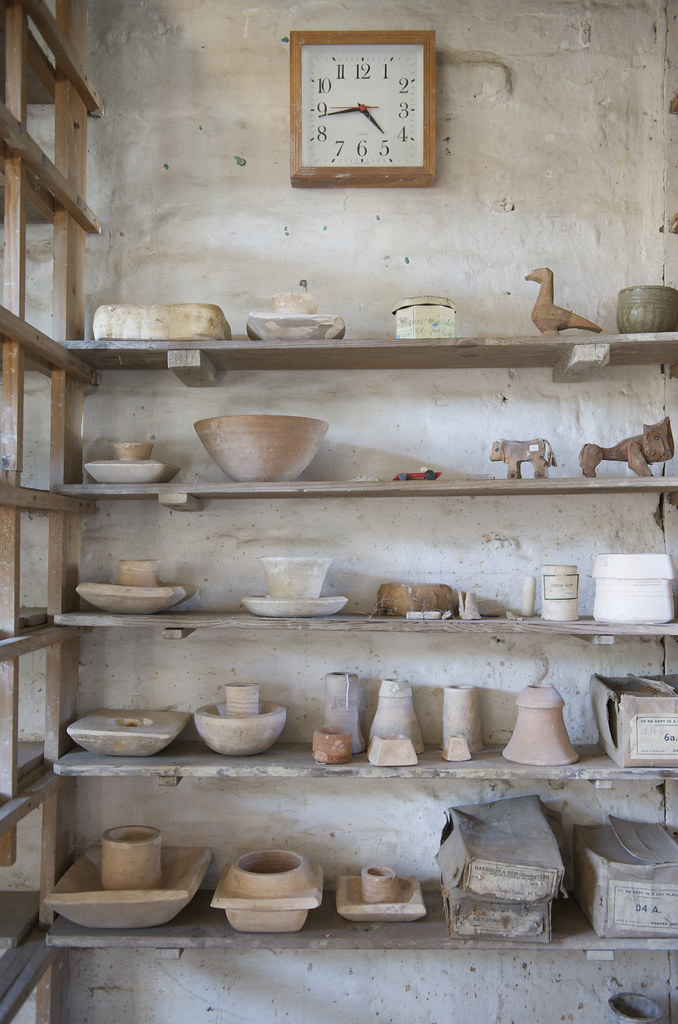 Ceramics studio with two kilns and shelves of ceramic work in a well-ventilated workshop space