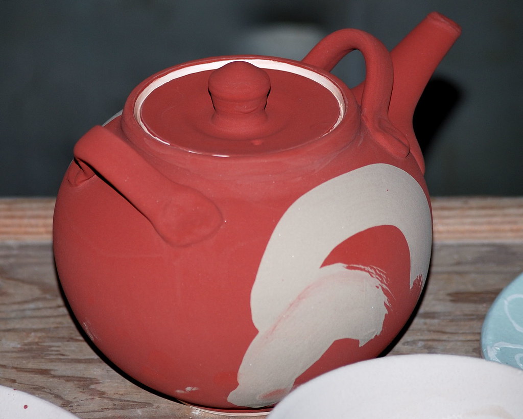 Handmade ceramic teapot on a wooden surface