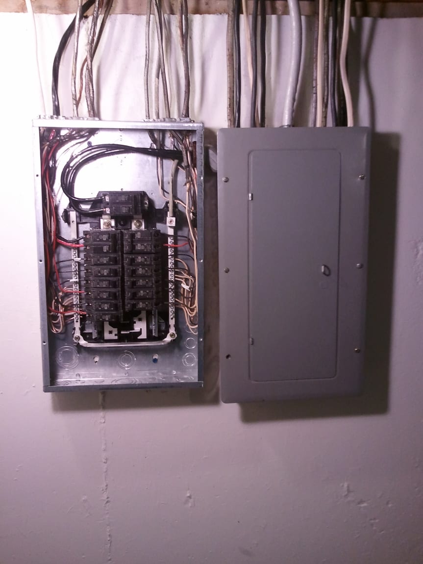 Open residential electrical panel and subpanel with the subpanel cover removed